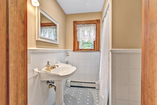 bathroom featuring a baseboard heating unit, tile walls, tile patterned flooring, and walk in shower