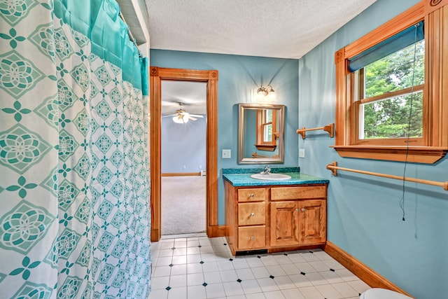 bathroom featuring a textured ceiling, vanity, a shower with curtain, tile patterned floors, and ceiling fan