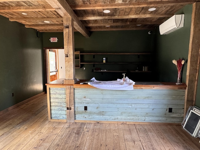 interior space with an AC wall unit, hardwood / wood-style floors, beamed ceiling, and wood ceiling