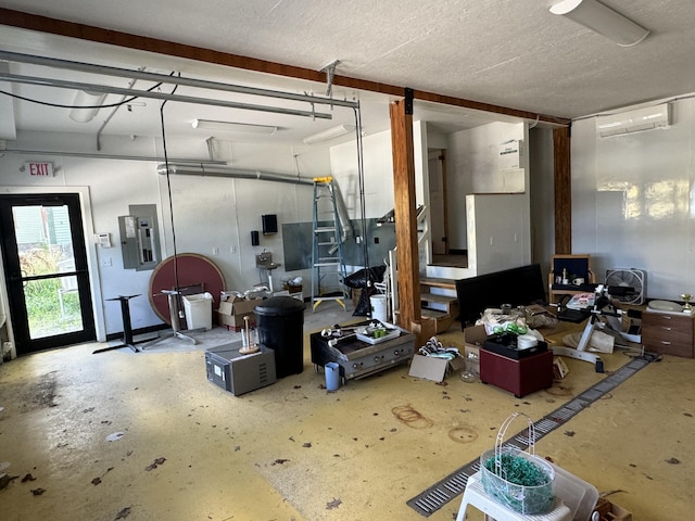 interior space with electric panel and a wall unit AC