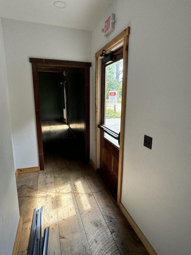 hallway with hardwood / wood-style floors