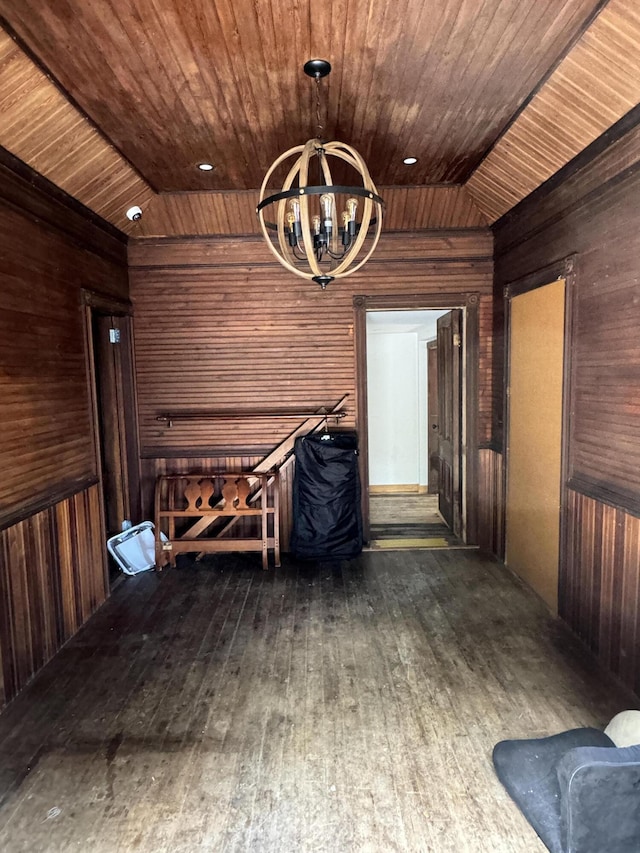 interior space featuring an inviting chandelier, wooden ceiling, dark wood-type flooring, and vaulted ceiling