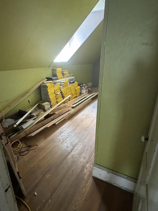 additional living space featuring dark hardwood / wood-style floors and lofted ceiling