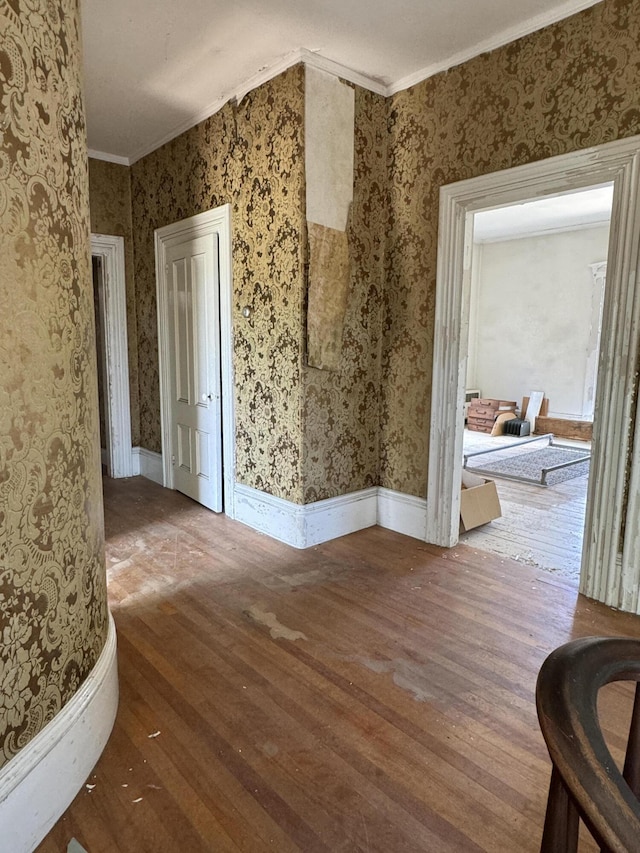 unfurnished room with hardwood / wood-style floors and ornamental molding