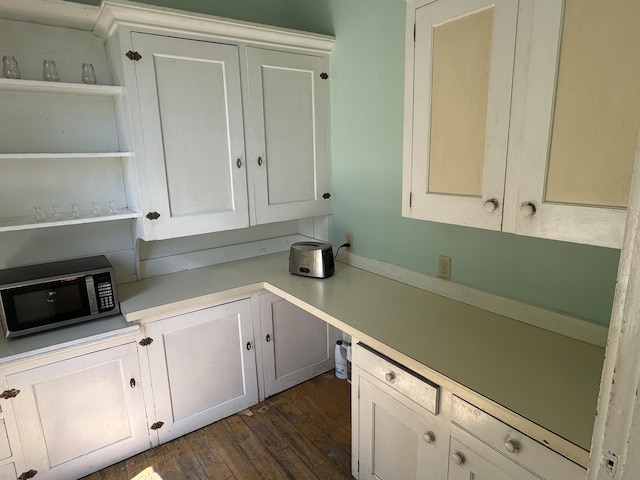 kitchen with white cabinetry and dark hardwood / wood-style floors