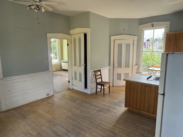 kitchen with white fridge, ceiling fan, a healthy amount of sunlight, and light hardwood / wood-style floors