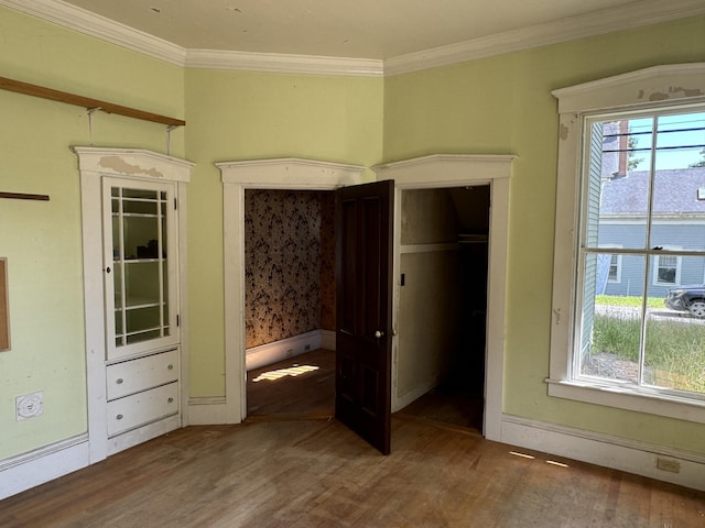 unfurnished bedroom featuring hardwood / wood-style floors and ornamental molding