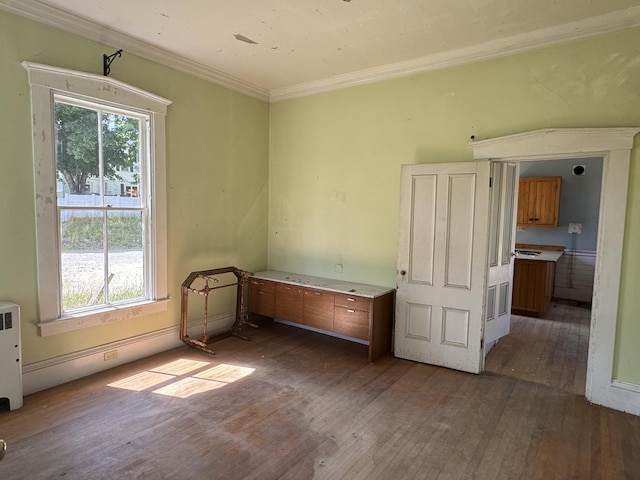 unfurnished room with a wealth of natural light, dark hardwood / wood-style flooring, and crown molding