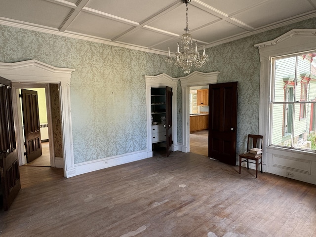 unfurnished dining area featuring a wealth of natural light, coffered ceiling, and hardwood / wood-style flooring