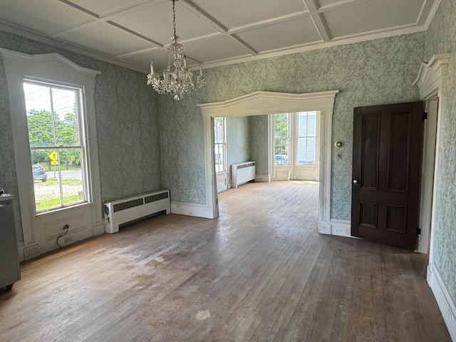 interior space featuring radiator, hardwood / wood-style floors, a healthy amount of sunlight, and coffered ceiling