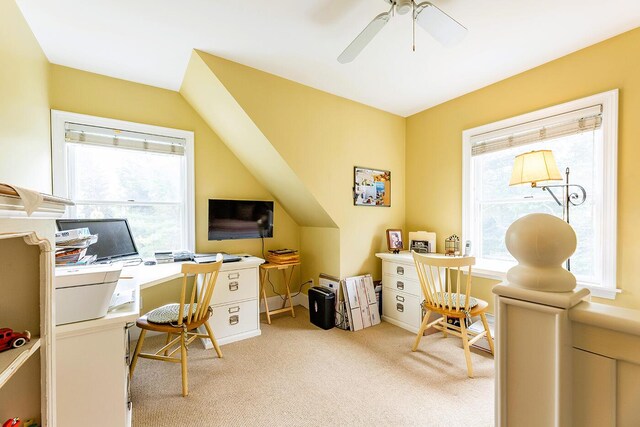 carpeted office space with ceiling fan