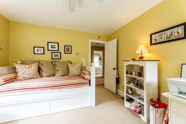 bedroom featuring a ceiling fan and light colored carpet