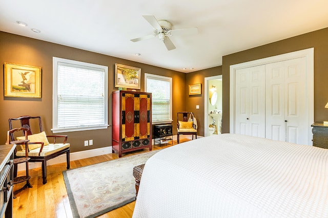 bedroom with ceiling fan, light wood-type flooring, and a closet