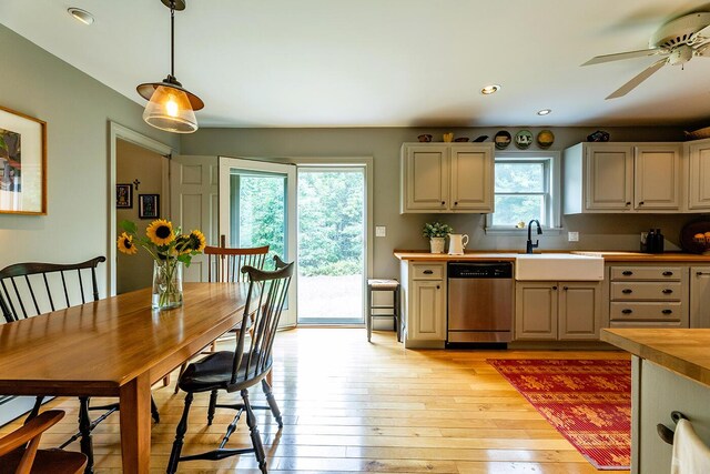 kitchen with a healthy amount of sunlight, dishwasher, ceiling fan, and decorative light fixtures