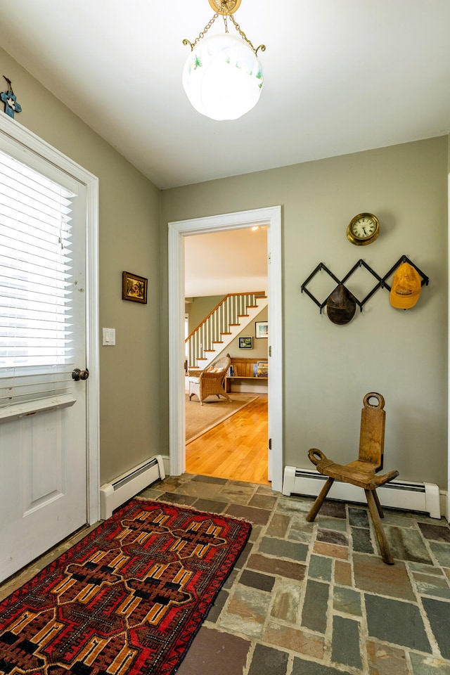 interior space with baseboard heating and dark wood-type flooring