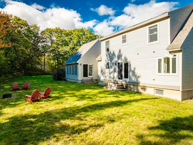 back of house with a yard and entry steps