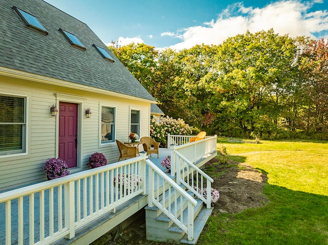 wooden deck featuring a yard