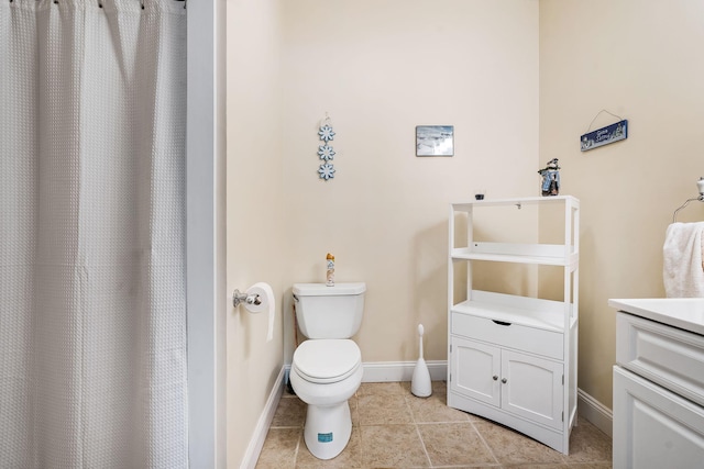 bathroom with vanity, toilet, and tile patterned floors