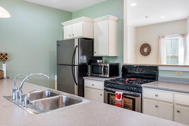 kitchen featuring white cabinetry, stainless steel appliances, and sink