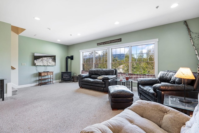 carpeted living room featuring a wood stove