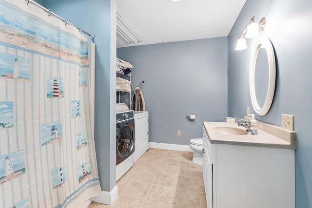 bathroom featuring tile patterned flooring, toilet, independent washer and dryer, and vanity