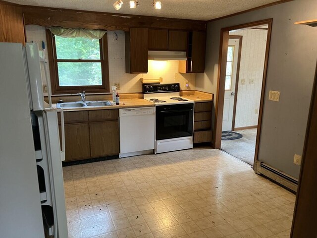 kitchen with white appliances, a textured ceiling, a baseboard radiator, and sink