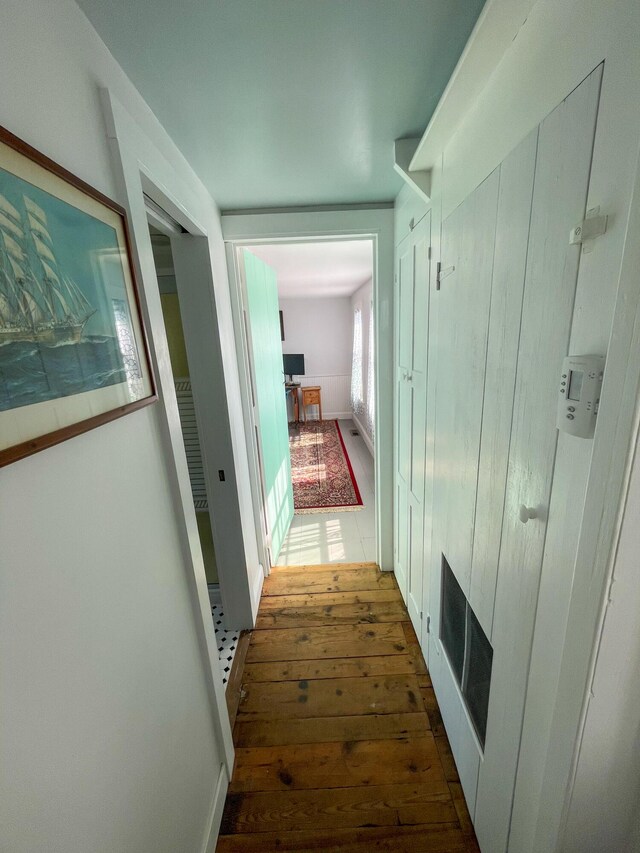 corridor featuring dark hardwood / wood-style flooring