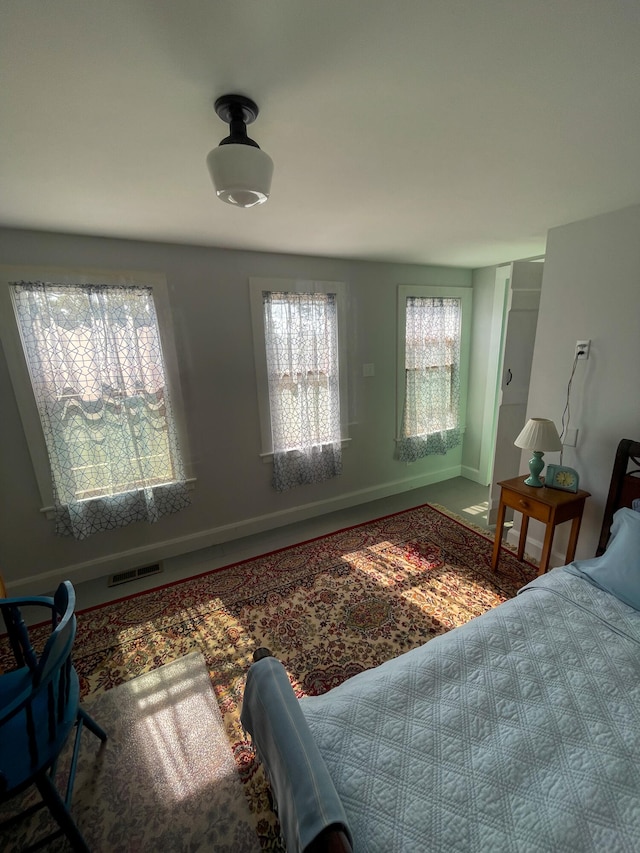 bedroom with a closet, visible vents, and baseboards