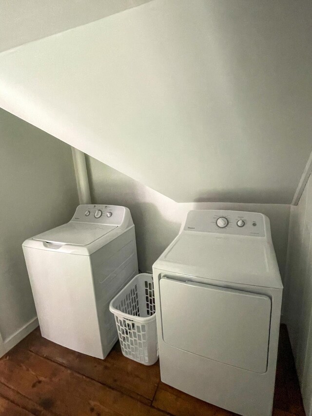 laundry area featuring washer and dryer, wood finished floors, and laundry area