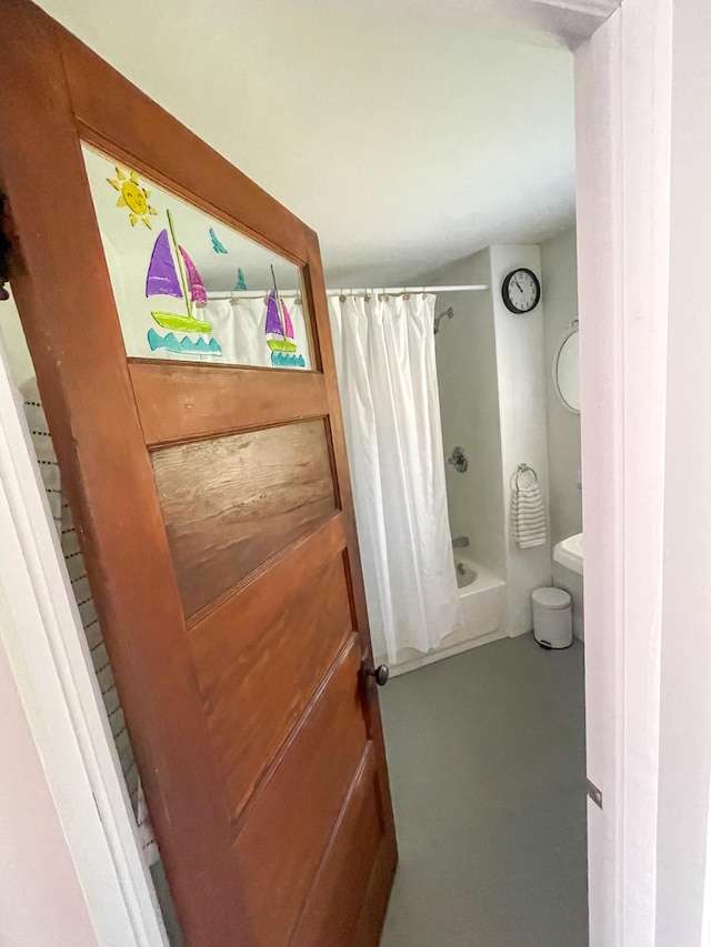 bathroom featuring shower / bath combo with shower curtain and toilet