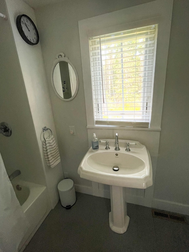 bathroom featuring plus walk in shower and tile patterned flooring