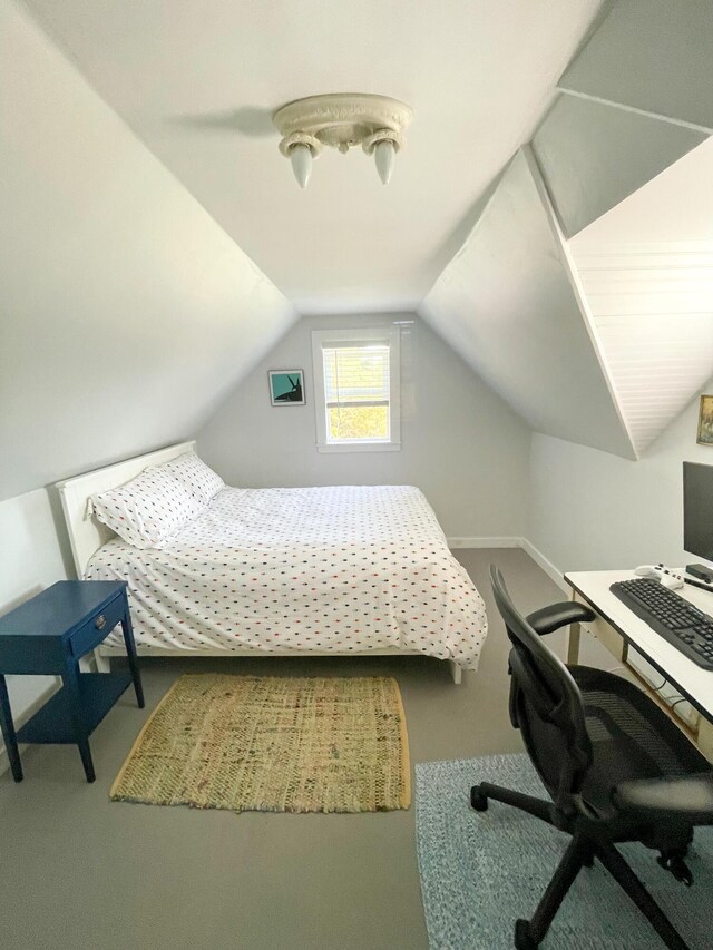 bedroom with carpet flooring and lofted ceiling