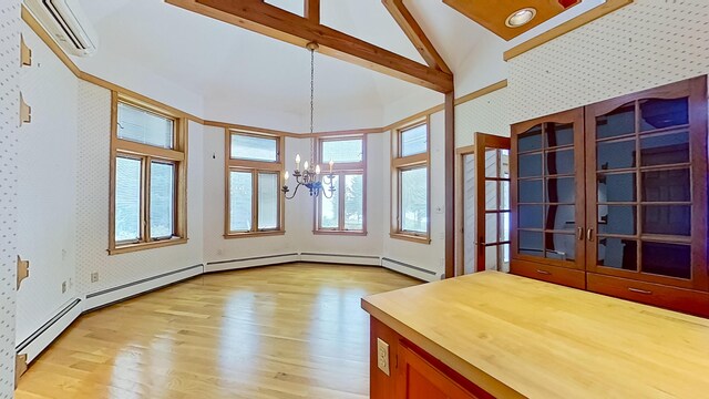 interior space featuring an inviting chandelier, vaulted ceiling with beams, and a wall mounted air conditioner