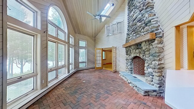 unfurnished sunroom featuring ceiling fan and vaulted ceiling