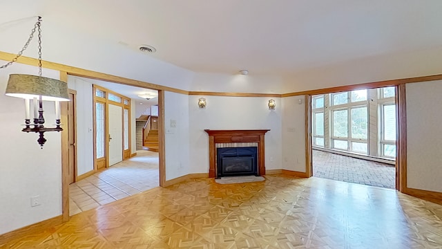 unfurnished living room with a baseboard heating unit and light parquet floors