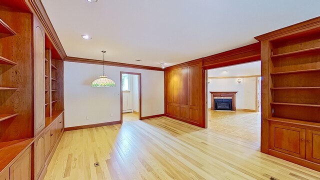 unfurnished room with light hardwood / wood-style flooring, ornamental molding, and a baseboard radiator