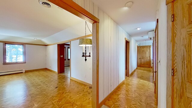 corridor featuring a baseboard heating unit, lofted ceiling, and light parquet flooring