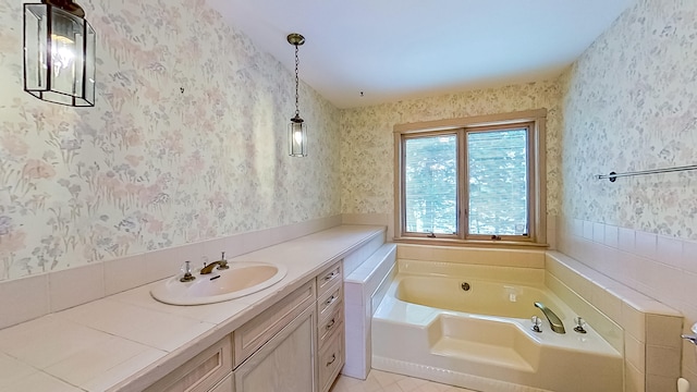 bathroom with vanity, a bathing tub, and tile patterned flooring