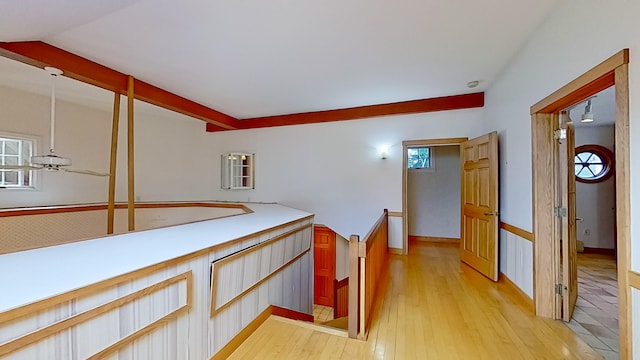 corridor featuring light hardwood / wood-style floors and vaulted ceiling