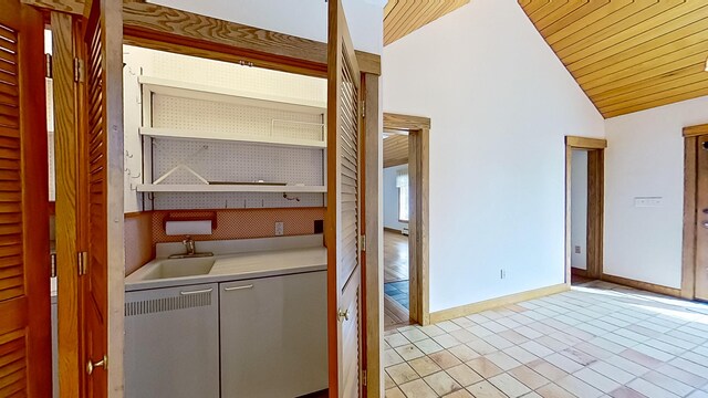 washroom with wooden ceiling, sink, and light tile patterned flooring