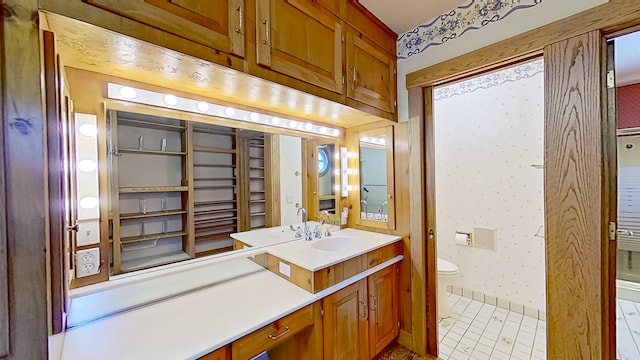 bathroom with vanity, toilet, and tile patterned flooring