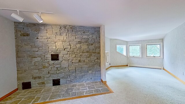 interior space with carpet flooring, baseboard heating, and a fireplace