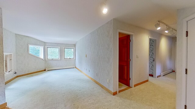 bonus room with a baseboard radiator and carpet floors