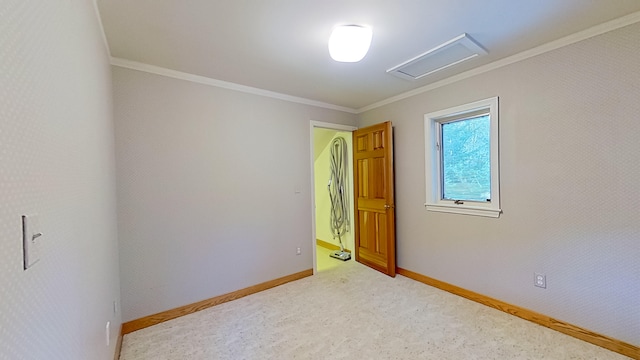 empty room featuring crown molding