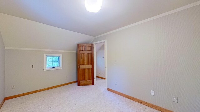 interior space featuring light carpet and vaulted ceiling