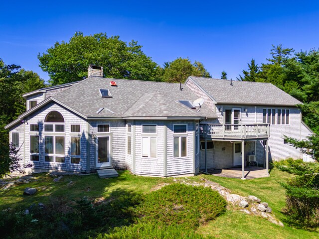 back of property with a yard, central AC unit, a patio, and a deck