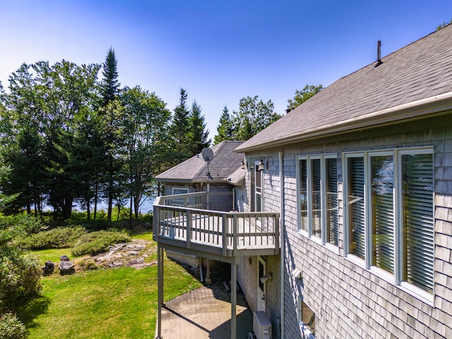 wooden deck featuring a lawn