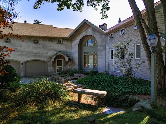 view of front of home with a garage and french doors