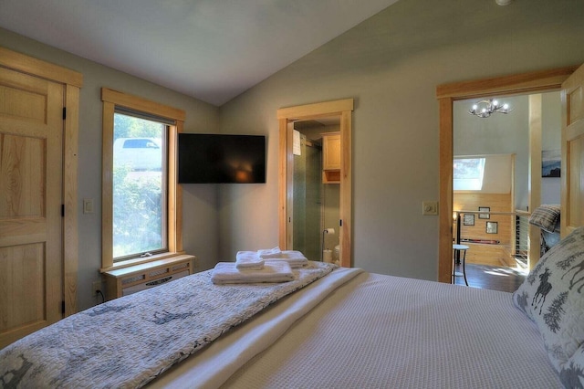 bedroom with vaulted ceiling and a chandelier