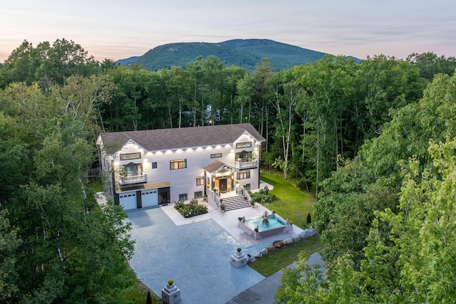 aerial view at dusk featuring a mountain view